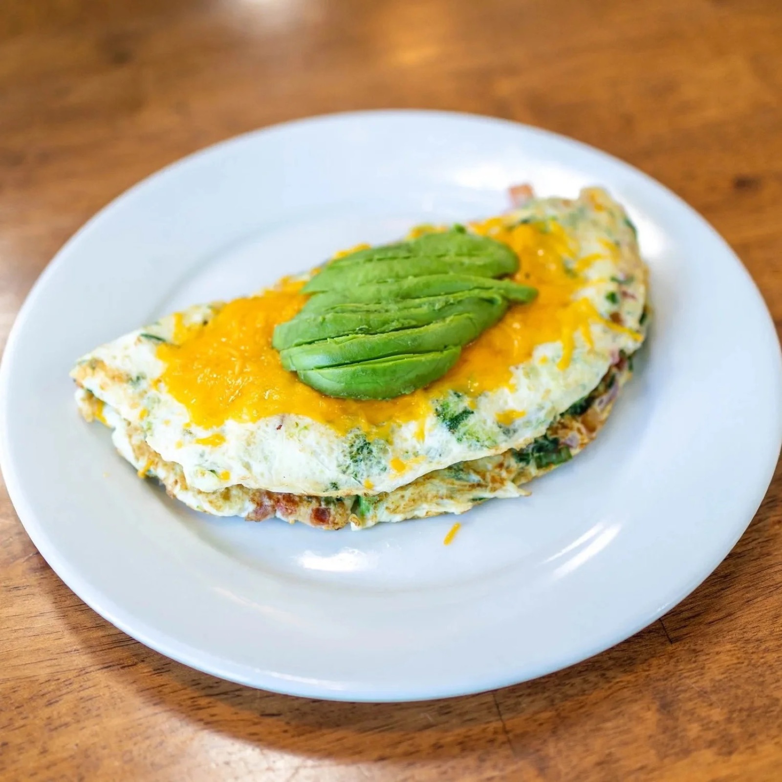 Healthy veggie omelette topped with avocado